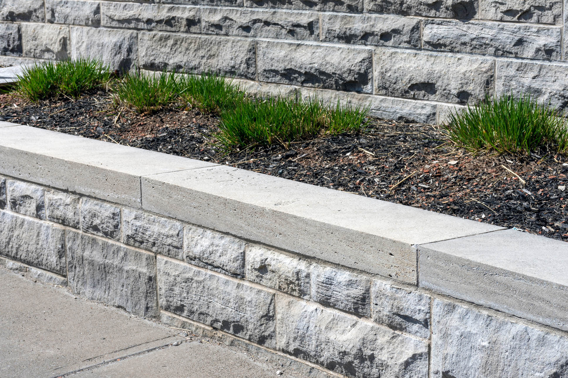 Constructed of stone, the raised bed in this walled garden acts